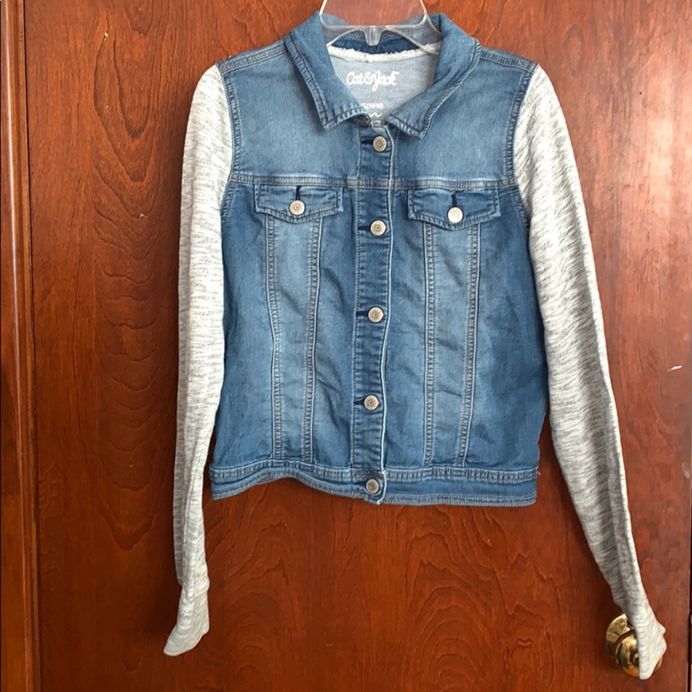 jean jacket with knit heather gray sleeves.
